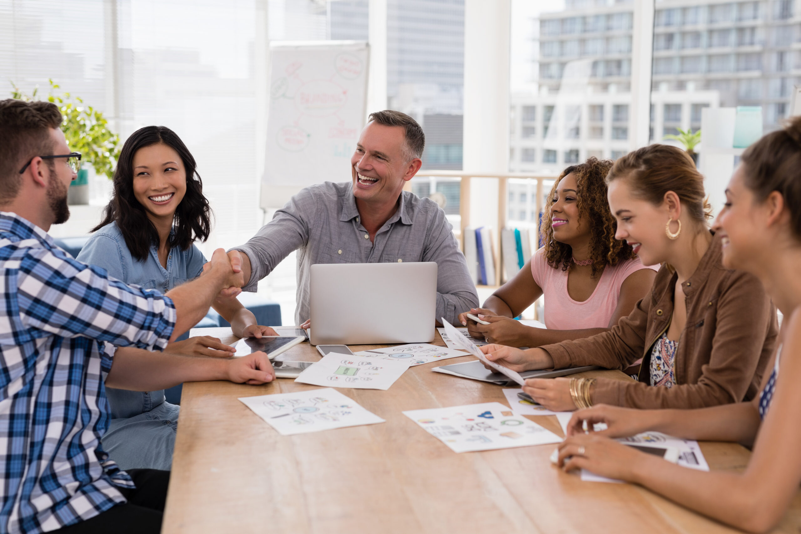 Executives shaking hands in the meeting at office